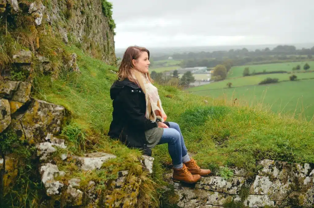 woman sitting on rock